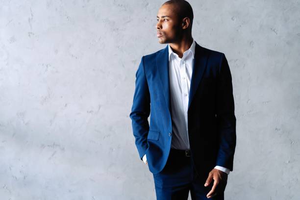 istock Cool african businessman standing on grey background. 1059341718