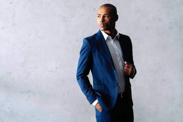 istock Cool african businessman standing on grey background. 1059341726