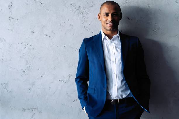 istock Cool african businessman standing on grey background. 1059341742