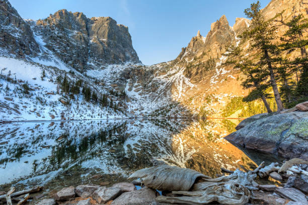 istock Driftwood and Emerald Lake Mountain Reflection 1059342138