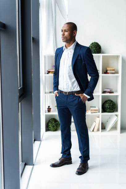 istock Handsome cheerful african american executive business man at the workspace office. 1059342832