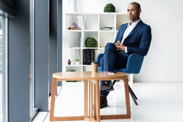 istock Handsome cheerful african american executive business man at the workspace office. 1059342836