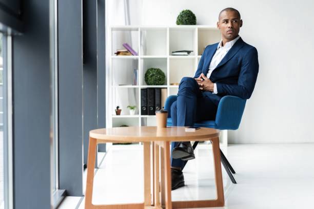 istock Handsome cheerful african american executive business man at the workspace office. 1059342848