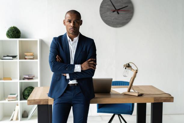 istock Handsome cheerful african american executive business man at the workspace office. 1059342854