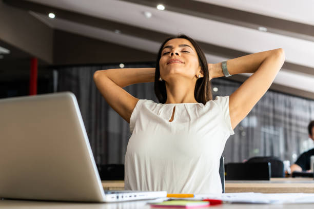 istock New solution every day. Confident young woman in smart casual wear working on laptop while sitting at her working place in office. 1059344834