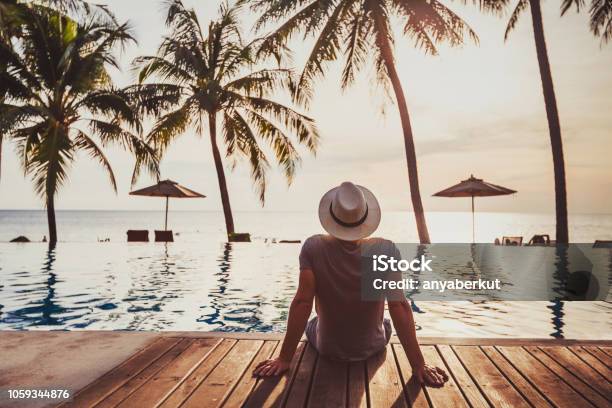 Holidays Tourist Relaxing In Luxury Beach Hotel Near Luxurious Swimming Pool Stock Photo - Download Image Now