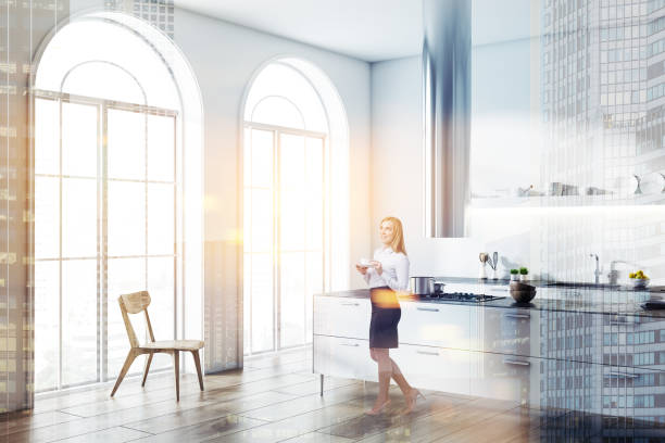 istock Woman in a white loft kitchen corner 1059347814
