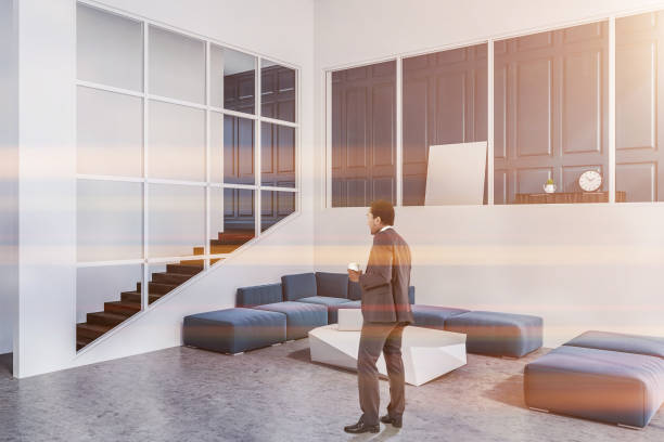 istock Blue sofa white living room corner, poster, man 1059348118