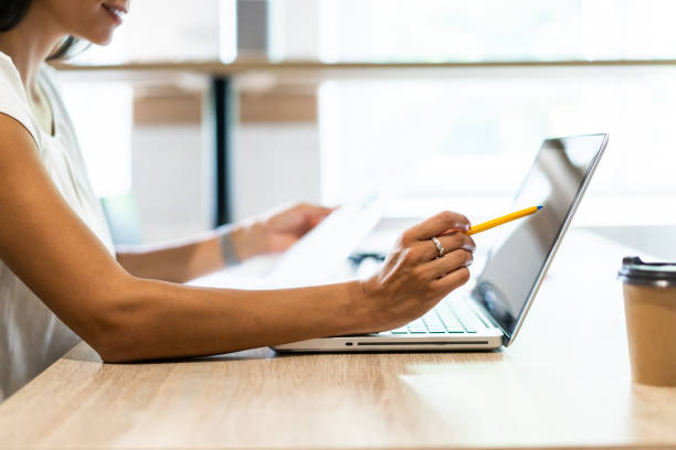 istock Financial report with pie chart and data on a laptop with business woman's hands at work 1059348444