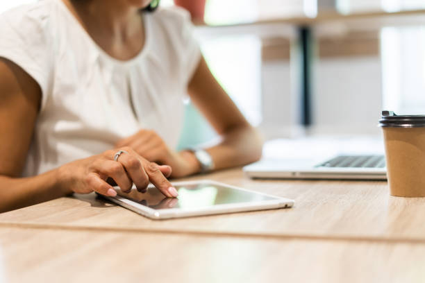 istock Lifestyle with modern woman using tablet or tablet computer with hand holding touchscreen. Hands of working woman with Smart Tablet reading online website . Business Concept 1059350864