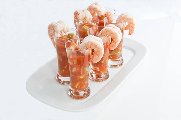 Shrimp cocktail served with fresh lemon slices and lemon blossoms