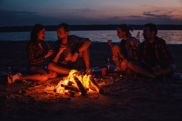 istock young friends have picnic with bonfire on the beach 1059359372