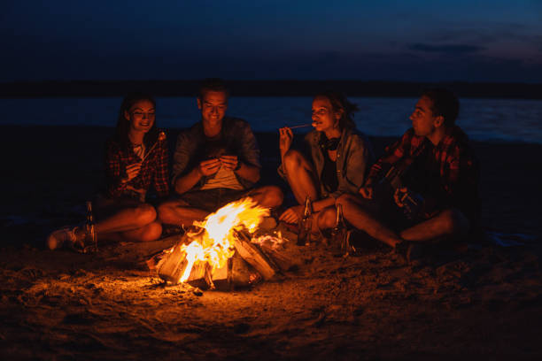 istock young friends have picnic with bonfire on the beach 1059359400