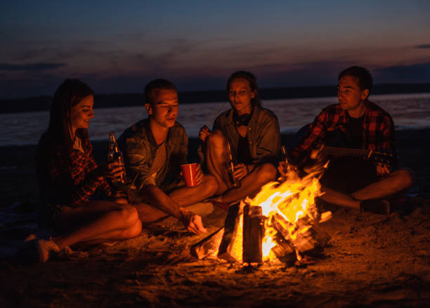 istock young friends have picnic with bonfire on the beach 1059359448