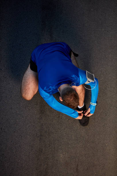 istock Top view of runner tying shoelace. 1059359452