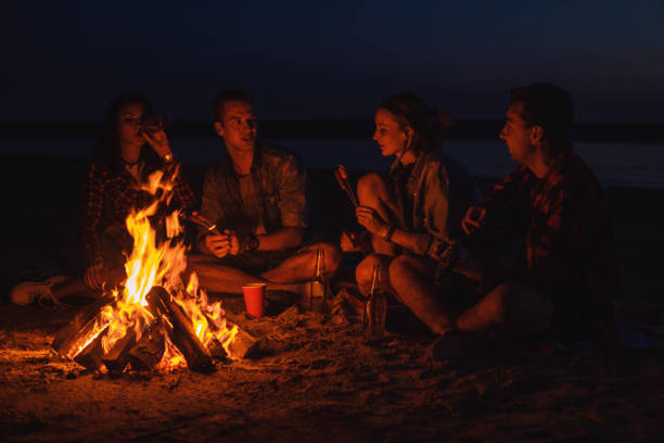 istock young friends have picnic with bonfire on the beach 1059359480