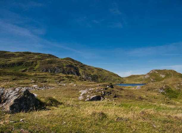 istock Small lake in a mountain landscape near Croaghlin 1059359634