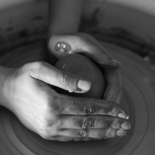 istock Potter's hands shaping up a piece of clay 105936023
