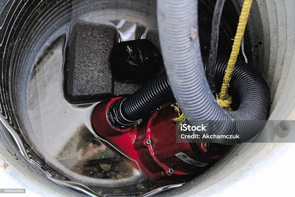 A sump pump with some water around it A sump pump with some water around it. Water Pump Stock Photo