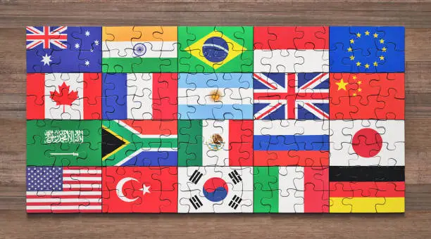 Flags of the G20 member countries in the form of puzzle pieces.