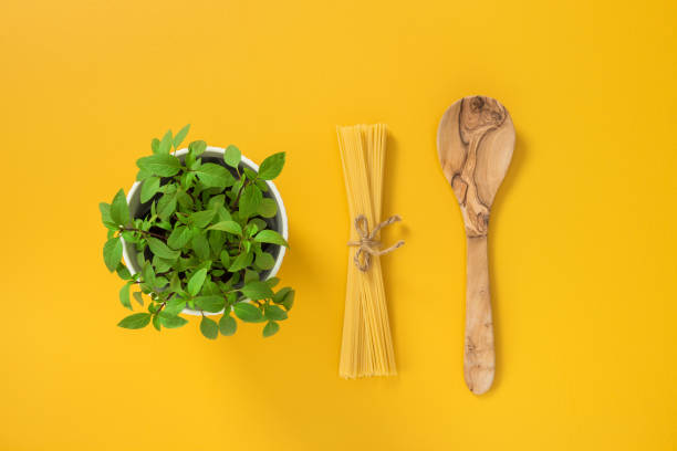 Basil, pasta and wooden spoon