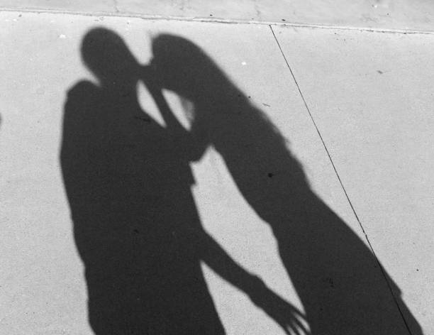 Girls making heart shape shadows with hands, and petting dog in shadows against wall. girl reading on chair and girls whispering to each other and walking with each other and girl praying.