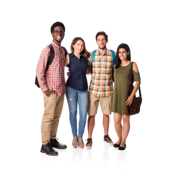 Four good-looking young students standing together and smiling