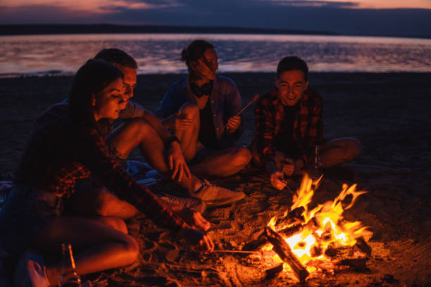 istock young friends have picnic with bonfire on the beach 1059367684