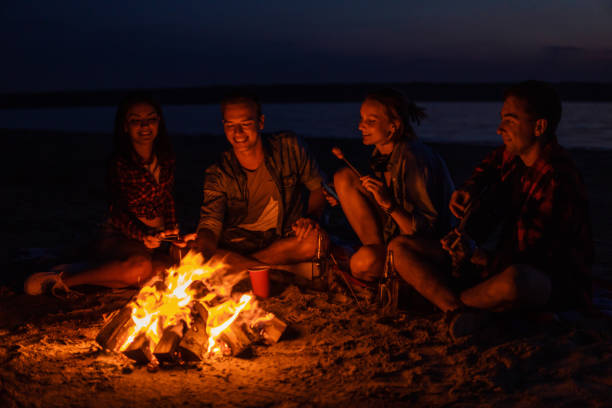 istock young friends have picnic with bonfire on the beach 1059367784