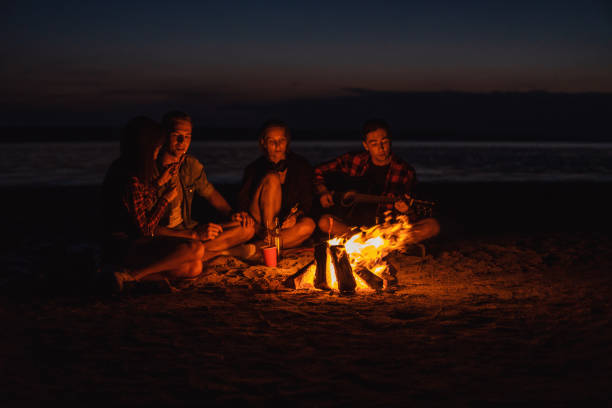 istock young friends have picnic with bonfire on the beach 1059367832