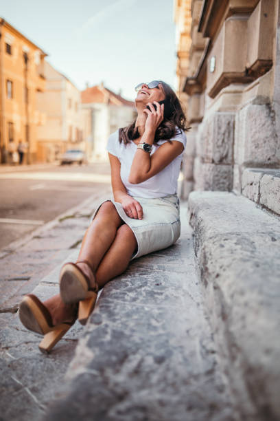 istock Young woman talking on mobile phone 1059369448