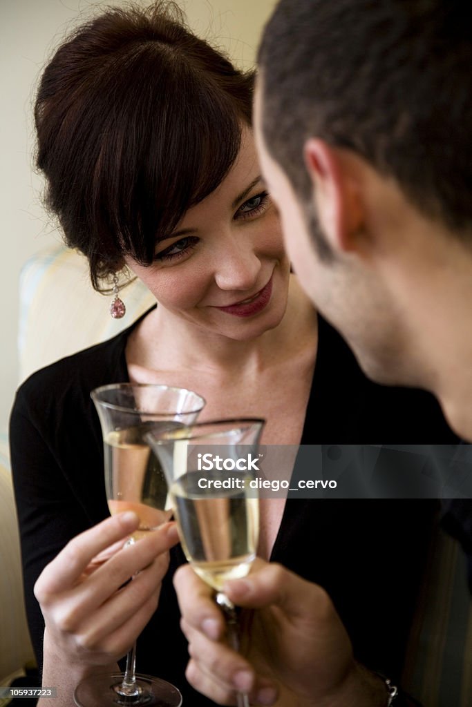 cheers young couple celebrating some occasion and having fun Adult Stock Photo