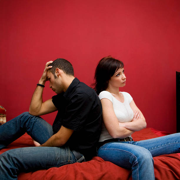 istock Woman and man sitting back to back on bed  105937272