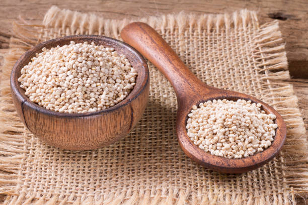 istock Quinoa seeds in bowl on rustic wood. 1059374768