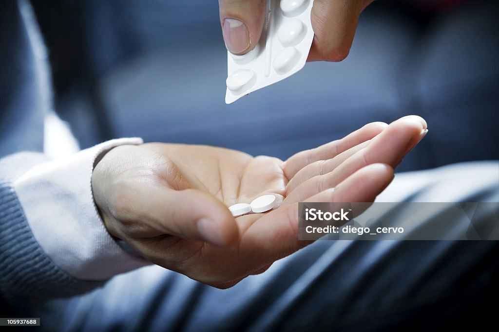 pills healthcare and medicine: man taking a painkiller Addiction Stock Photo