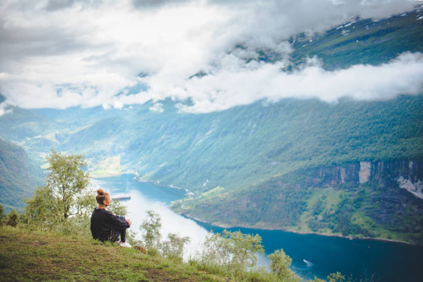 istock Woman overlooking stunning nature in Norway. 1059380170