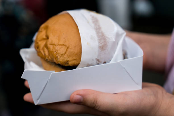 istock Hands holding a delicious burger with a blank package 1059386384