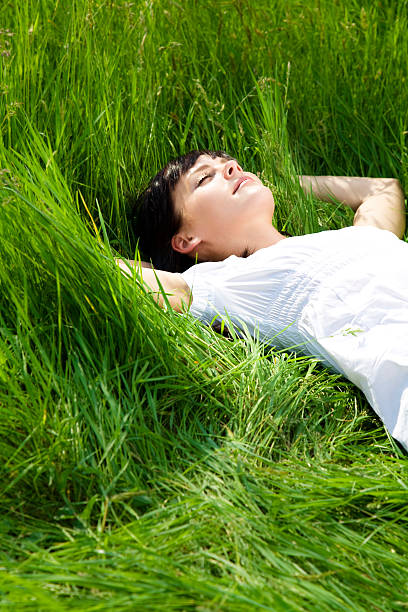istock Person laying in grass in meadow 105938654