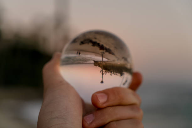 istock Hand holding a crystal ball on the beach 1059388130