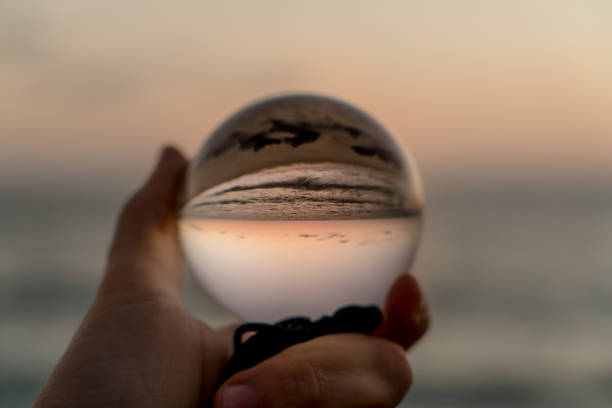 istock Hand holding a crystal ball on the beach 1059388212