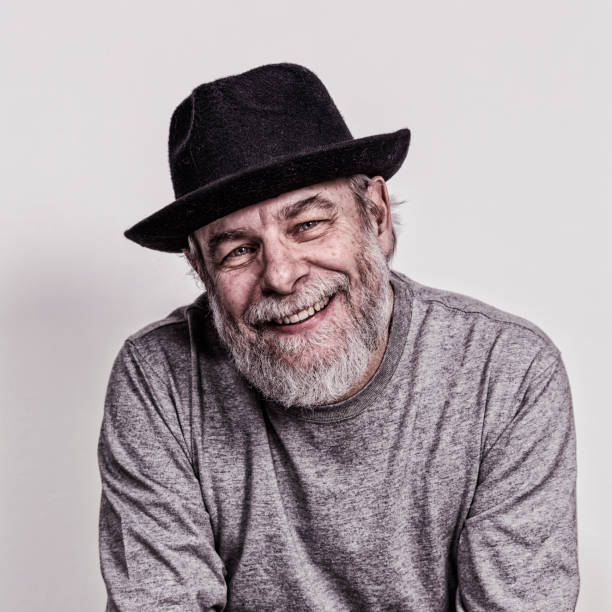 istock Melancholy Senior Man Wearing Black Fedora Smiling 1059390418