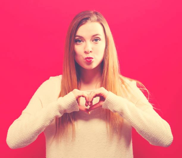 istock Woman making a heart shaped gesture 1059391306