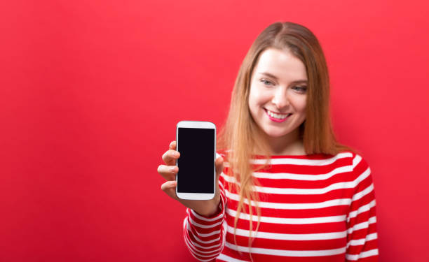 istock Young woman holding out a cellphone 1059391346
