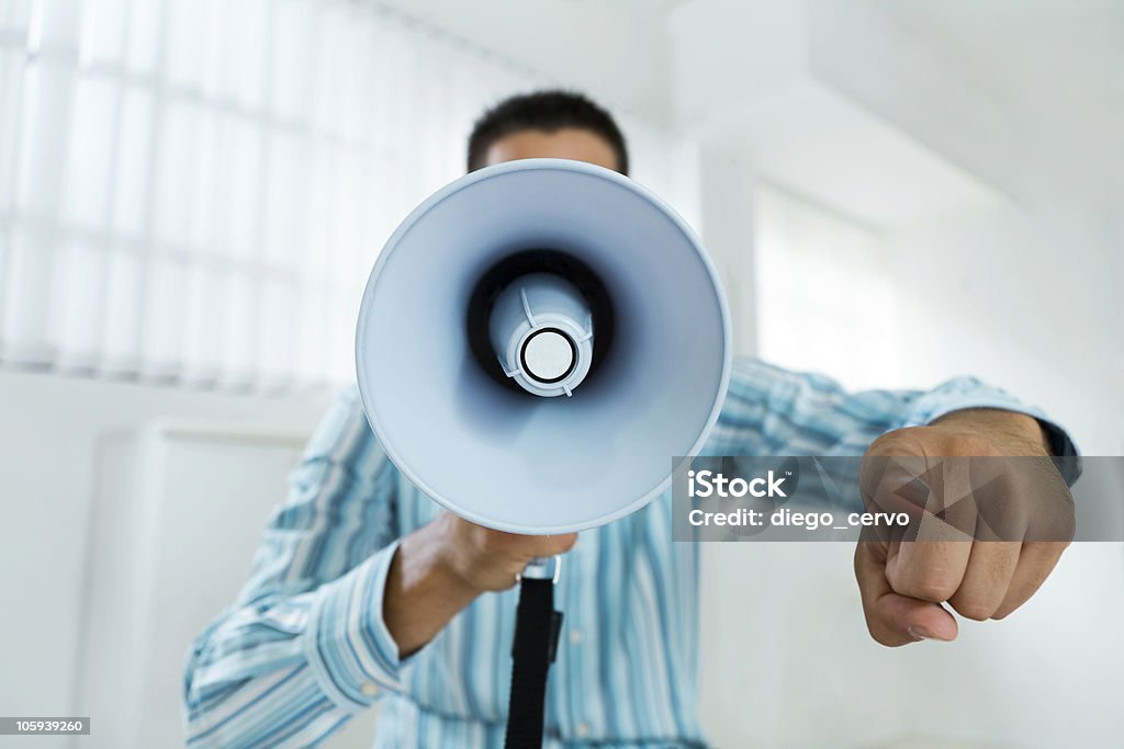 megaphone young businessman in office screaming on the megaphone Front View Stock Photo