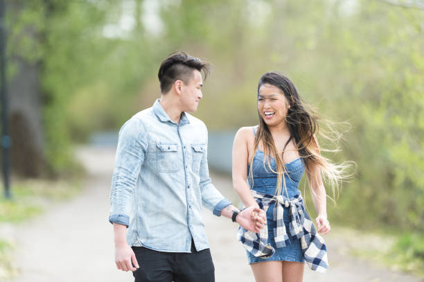 istock Asian couple walking together through a park 1059392988
