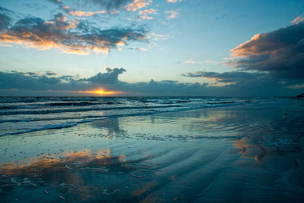istock Sunset over Wet Sand on Beach 1059394664