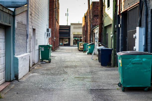 istock City alley with trash, dumpsters, and garbage cans 1059401604