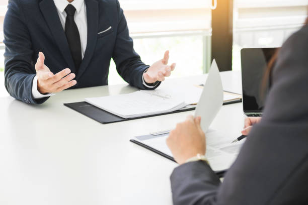 istock Midsection Of Colleagues Working On Office Desk 1059402662