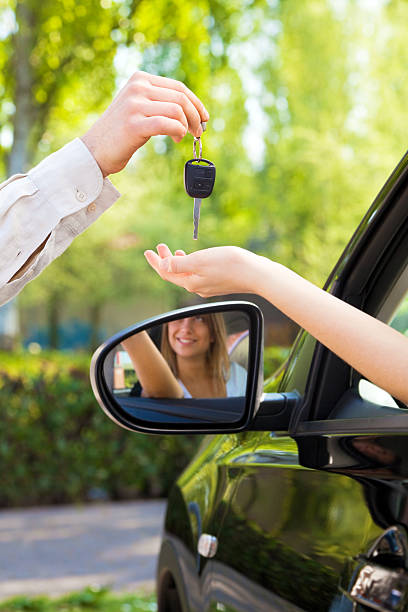 istock A man hands a female driver the car keys through the window 105940415