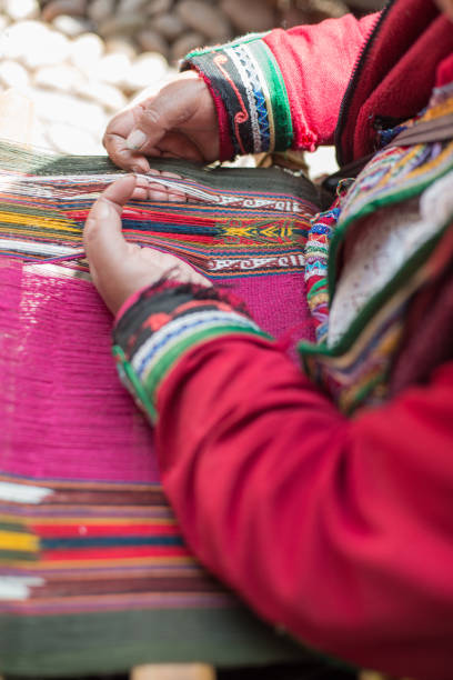 istock Quechua Peruvian woman weaving traditional textiles in Cusco. Peru 1059407390